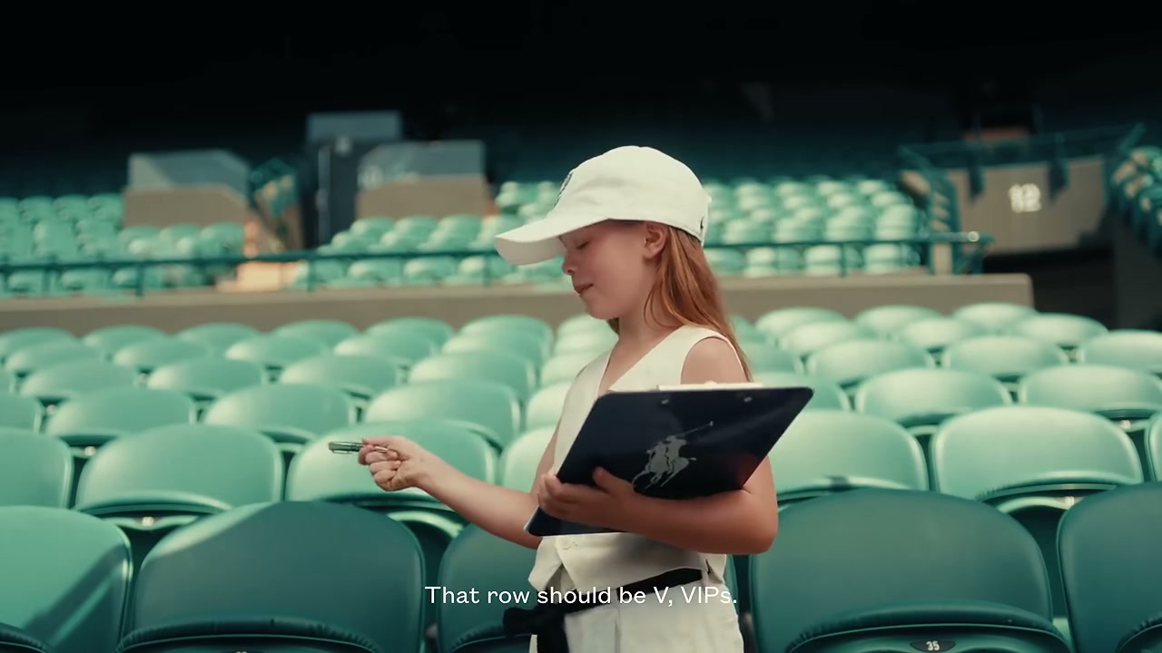 Frame from the peak beat: two children discussing VIP seating rows courtside.